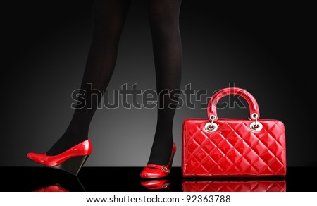 fashionable woman with a red bag, only legs
