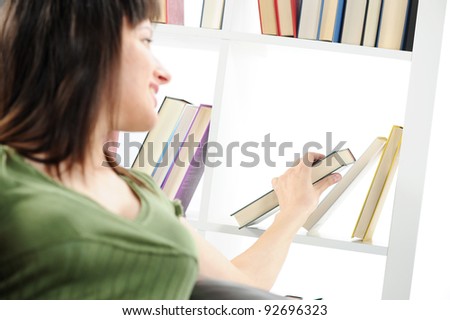 young Woman looking for a book at the bookshelf , similar photo on my portfolio
