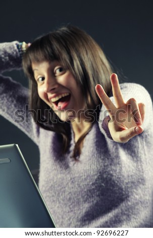 portrait of woman with a laptop cheering in success, similar pictures on my portfolio
