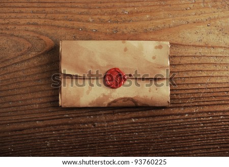 wax seal on a letter paper , background is wooden table