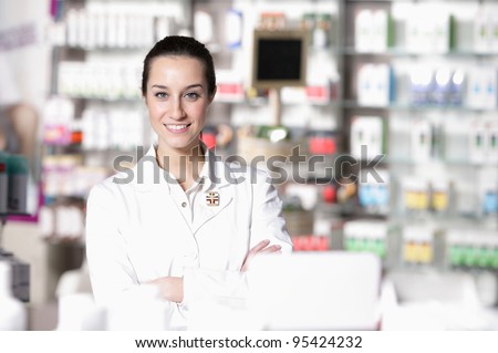 portrait of young health care worker and background pharmacy.