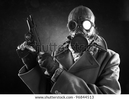 grunge portrait man in gas mask  with gun