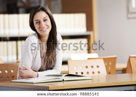 student in a library, portrait of smiling young woman