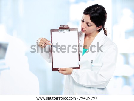 Female doctor holding blank clipboard. You can add your message to the clipboard.