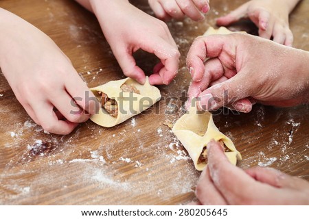 Cooking together with children. Children leaning how to make manti (Central Asia dumplings).
