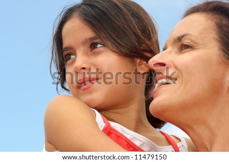 Mother and daughter looking far forward.  This photo could be used as concept of optimism and looking towards the future.