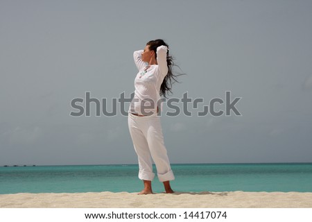 Woman, sun and ocean. Young beautiful brunette woman enjoying sun and ocean during her Caribbean vacation.