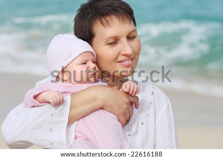 Mother and daughter on the turquoise ocean background. Caribbeans.