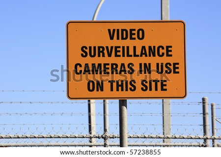 an orange warning sign, Video Surveillance Cameras in use on this site