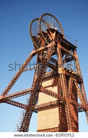A headframe, winding tower, poppet head or pit head, is used in shaft mining to support the winding mechanism. The mine shaft is used to gain access to an underground mining facility. Australia.
