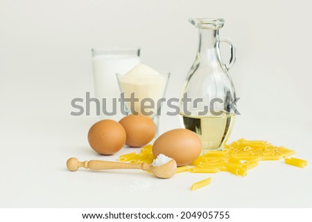 ingredients ( eggs, flour, milk, salt ) to make a macaroni, pasta, cake