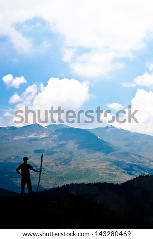 Explorer with a hiking stick viewing the world