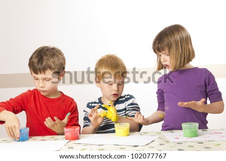 Children having fun painting with finger paint