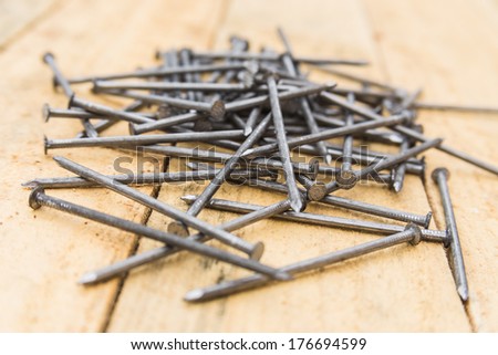 many gray nails on wooden boards