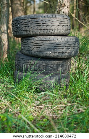 Old tires left in the woods. Illegal waste dump.
