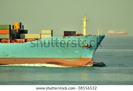 Container ship designed for transporting of containers, sailing on the sea surface