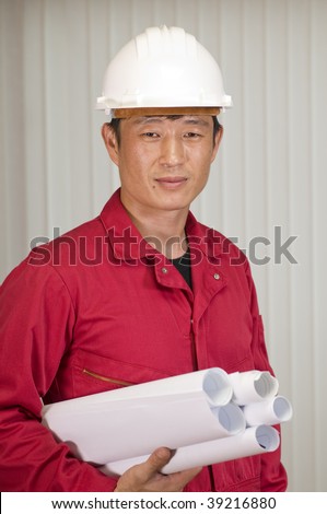 Happy young shipping marine engineer, working in office