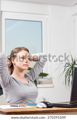 Photo of young business woman stretching at home office