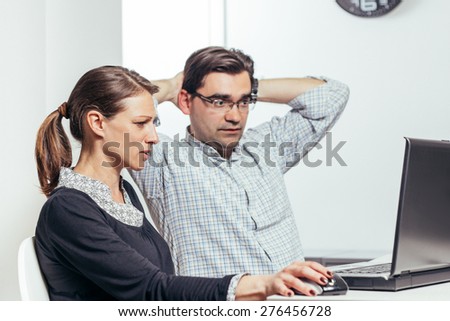 Photo of two people working late
