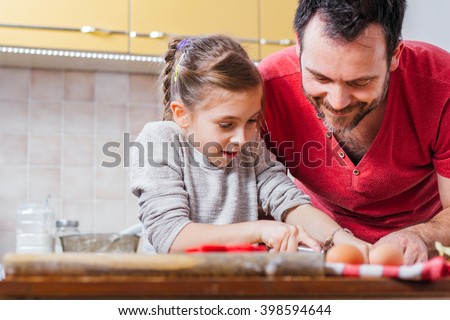 Father and daughter making dough