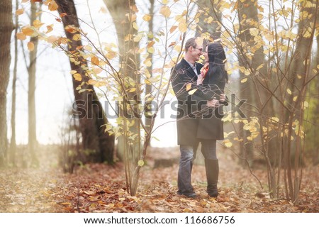 Fall in love with the park, young man and woman hugging