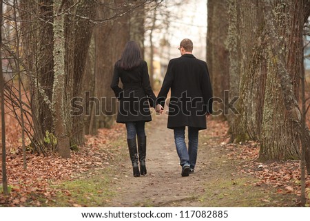 young men and women leaving the path in the park