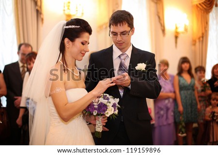 groom wears a wedding ring on the bride\'s wedding in Russia