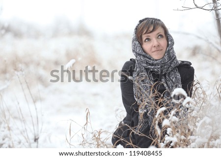 young woman in a winter forest with snow Christmas