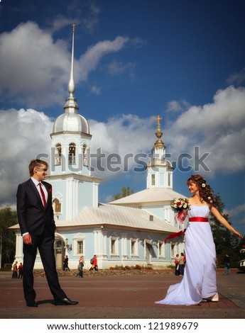 Wedding ceremony in the church, the wedding, the groom and bride in white dress in front of the church in the summer