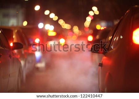 cars at night in a traffic jam in winter frost