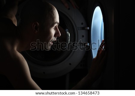 Man Looking inside the washing machine