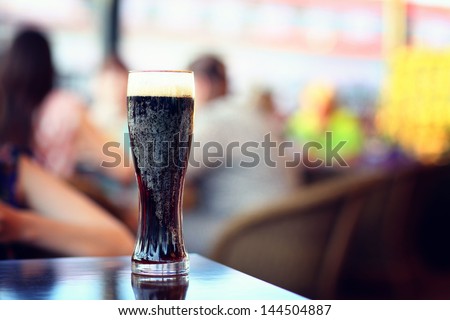 glass of dark beer in a restaurant