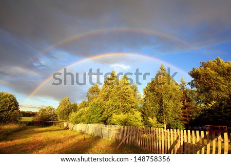 Rainbow over forest and field