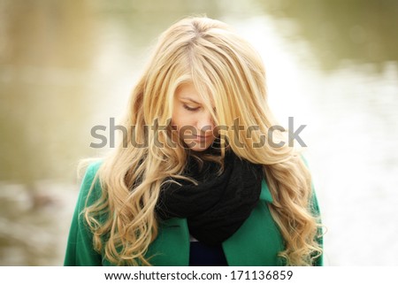 face portrait of a beautiful blonde in autumn winter coat