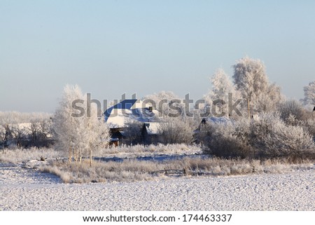 Winter in the village, wooden house