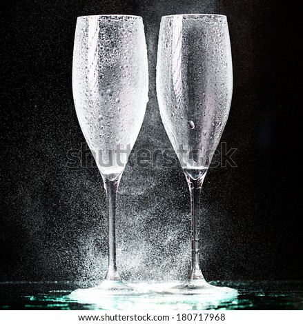 champagne glasses on black spray