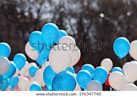 Blue and white balloons crowd