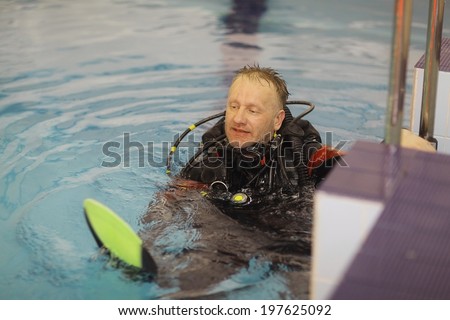 man teaches diving in the pool, swim coach
