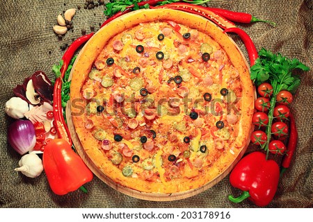 pizza with vegetables and herbs rustic background