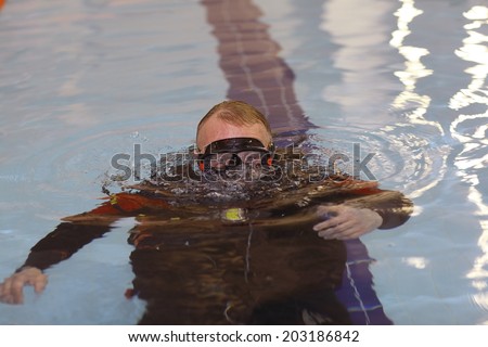 man teaches diving in the pool, swim coach