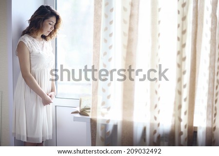 thoughtful girl at the window