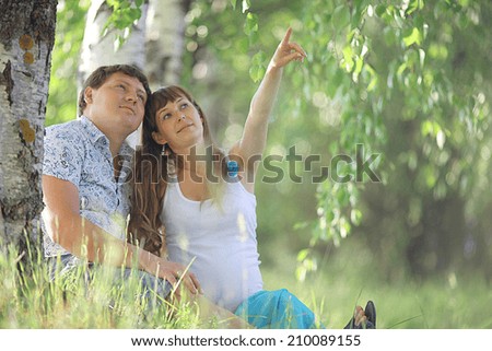 man and a pregnant woman happy nature