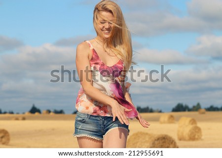 blonde girl with golden hair in the field