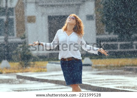rain city happy girl jumping in the puddle