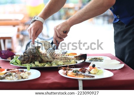 fish restaurant, fish is cut, the waiter hands