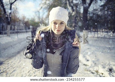 Winter portrait of young girl with headphones music