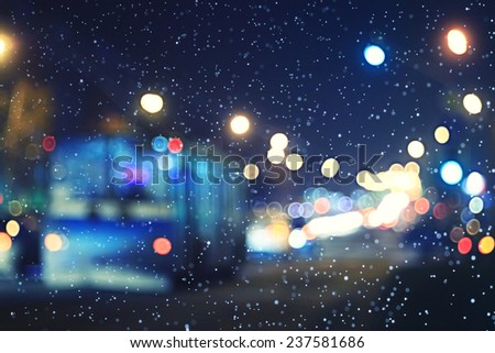 blurred night background city traffic road city lights winter snow glare