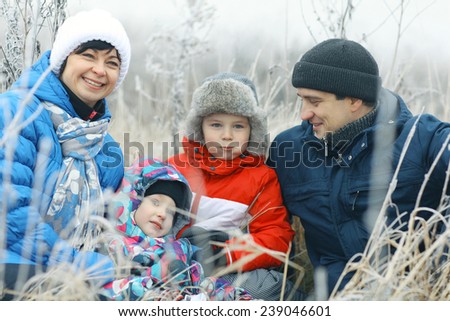 family with two children in the winter on the nature