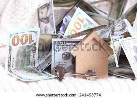 wooden toy house - the concept of housing purchase mortgage dollars cash money