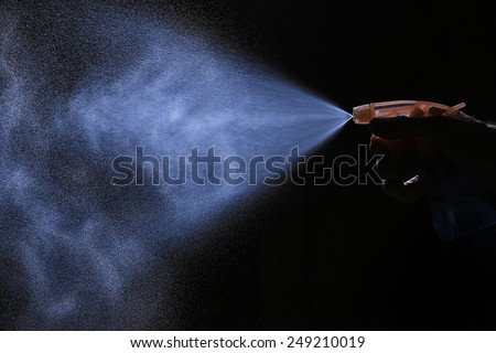 spray from the atomizer spray on black background overlay